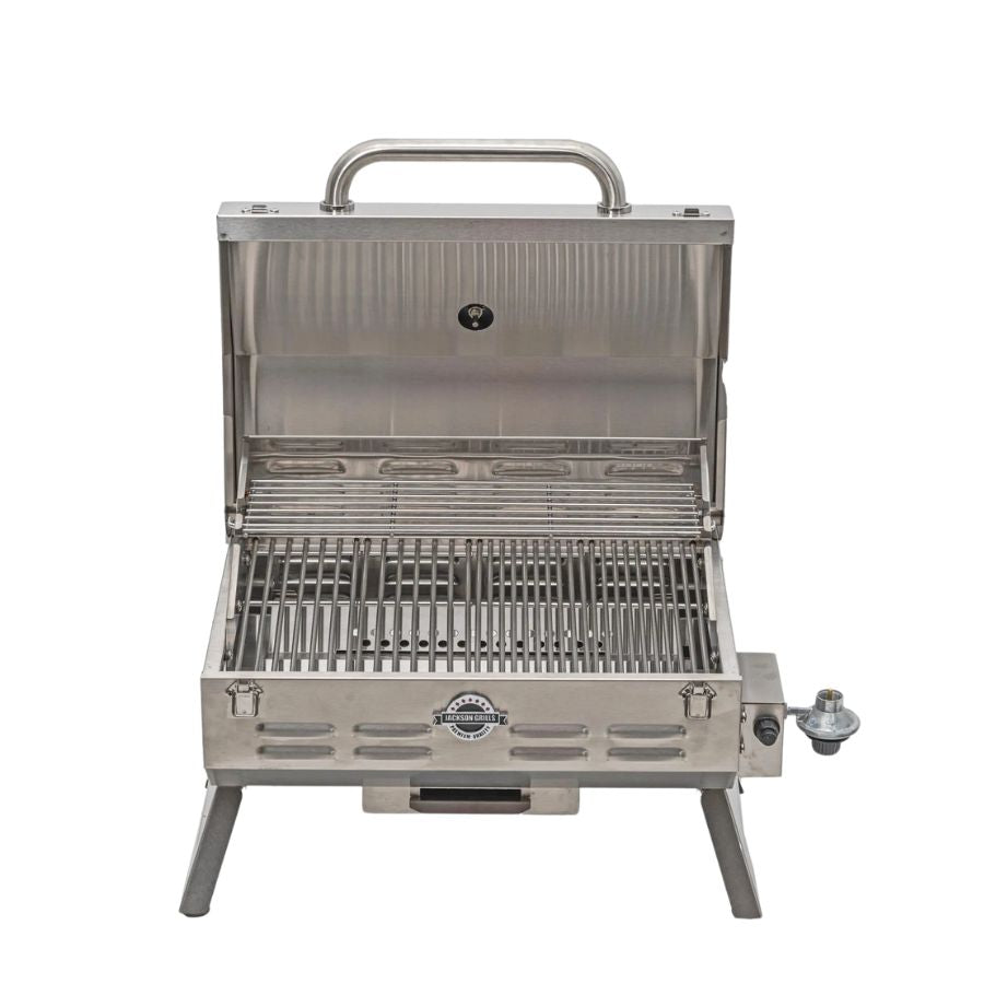 Front view of the Jackson Grills Versa 100 Portable Stainless Steel Gas Grill with the lid open, displaying its stainless steel grilling surface and high-quality construction.