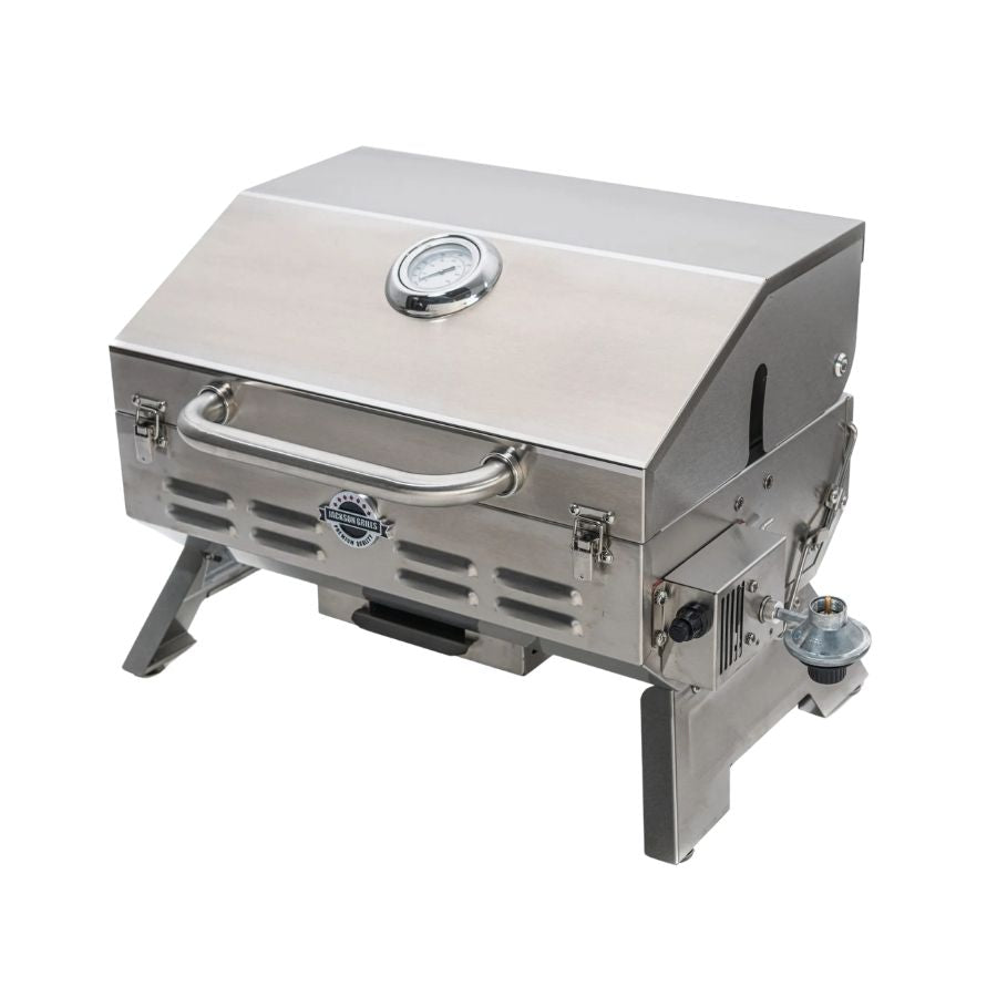 Side angle view of the Jackson Grills Versa 100 Portable Stainless Steel Gas Grill, highlighting its sleek design and portable features.