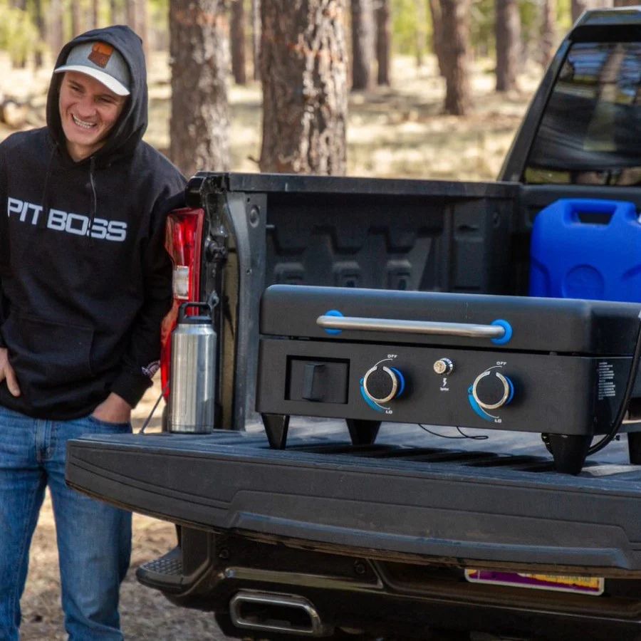 Pit Boss Lift-Off Griddle placed on truck bed for portable outdoor cooking