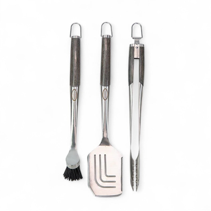 Grilling utensil set from Louisiana Grills, featuring a basting brush, spatula, and tongs