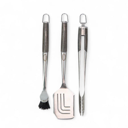 Grilling utensil set from Louisiana Grills, featuring a basting brush, spatula, and tongs