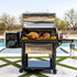 Louisiana Grills Founders Legacy 1200 Pellet Grill with open lid, cooking meats and vegetables outdoors.