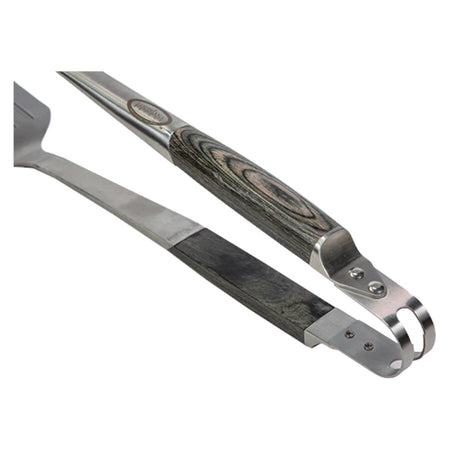 Close-up of the Louisiana Grills All-in-One Tool, highlighting its spatula, cleaver, and tong capabilities