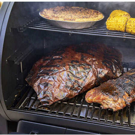 Pit Boss peach butcher paper being used to wrap a large cut of meat for smoking
