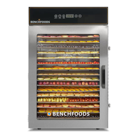 Straight-on front view of a single-zone BenchFoods 16-tray commercial dehydrator filled to capacity with colorful rows of sliced fruits on stainless steel mesh trays.