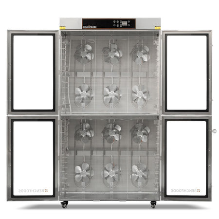 Interior layout of the BenchFoods 28CUDG commercial dehydrator with all doors wide open and trays removed, revealing the 12 rear-mounted high-velocity circulation fans.
