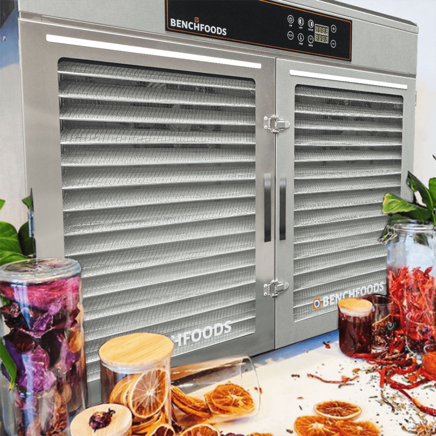 BenchFoods 32HCUDG horizontal commercial dehydrator front view styled with jars of dehydrated foods