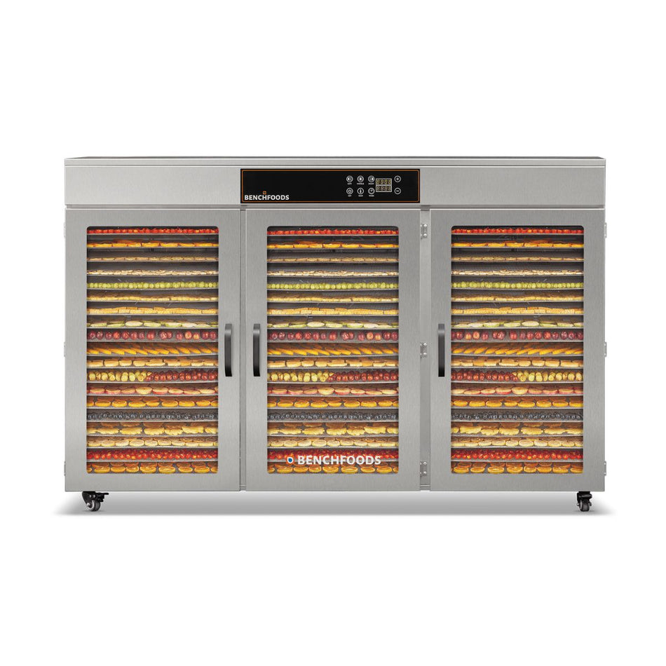 Front straight-on view of the BenchFoods 60CUDG 60-Tray Commercial Dehydrator with doors closed, fully loaded with colorful sliced fruits and vegetables on every tray.