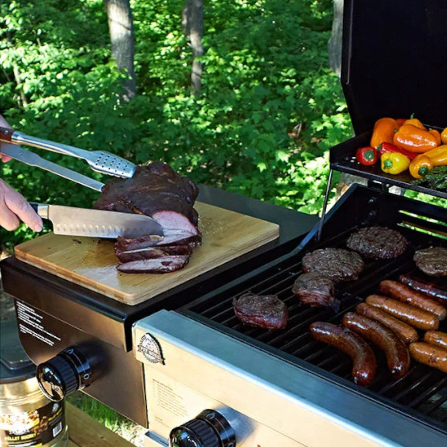 Cutting Meat in a Pit Boss Wooden Magnetic Cutting Board, showcasing its smooth wooden surface and magnetic strip