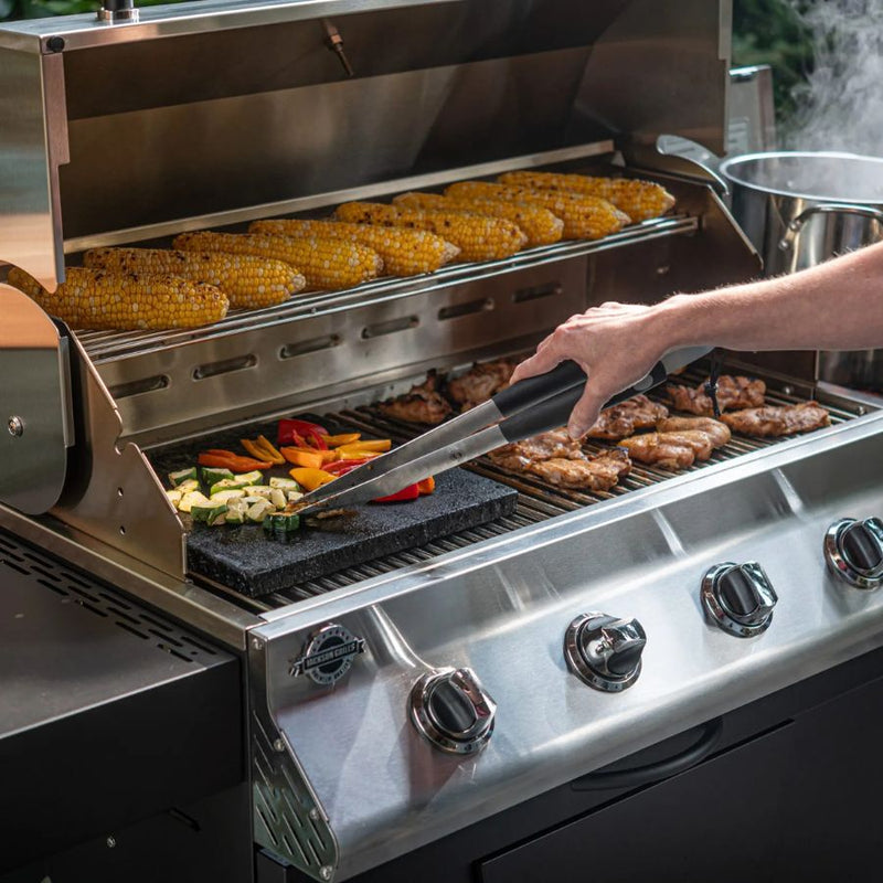 Jackson Grills tongs being used to grill vegetables on a BBQ