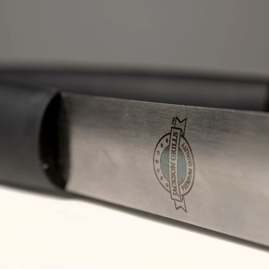 Close-up of Jackson Grills logo on stainless steel tongs