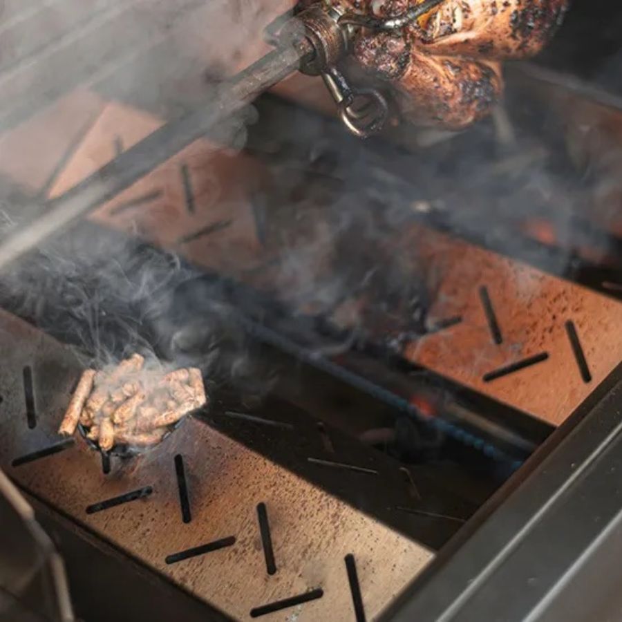 Jackson Grills Pellet Diffuser in use with wood pellets producing smoke