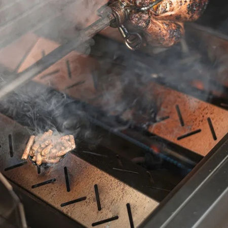 Jackson Grills Pellet Diffuser in use with wood pellets producing smoke