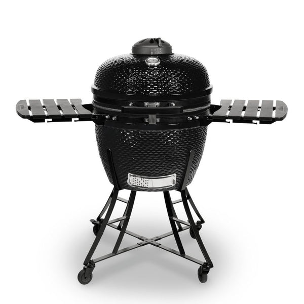 Louisiana Grills 24" Ceramic Kamado Charcoal Grill in black finish, featuring foldable side shelves, a built-in thermometer, and a sturdy wheeled stand.