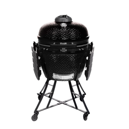 Louisiana Grills 24" Ceramic Kamado Charcoal Grill with foldable side shelves, showing its compact design for easy storage and mobility.