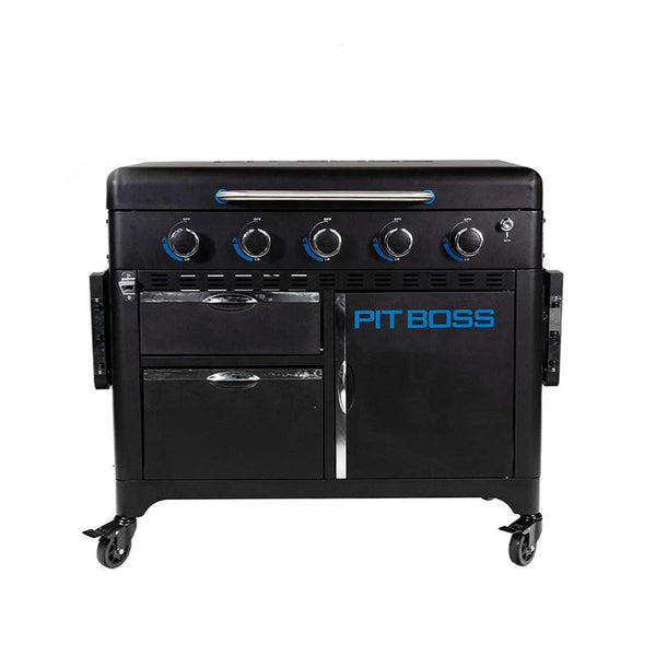 Front view of the Pit Boss 5-Burner Ultimate Griddle with lid closed and storage cabinets visible