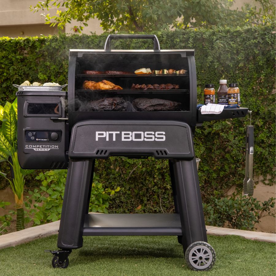 Pit Boss Competition Series 1250 Wood Pellet Grill in action, cooking smoked brisket, chicken, and vegetables, producing flavorful wood-fired barbecue outdoors.