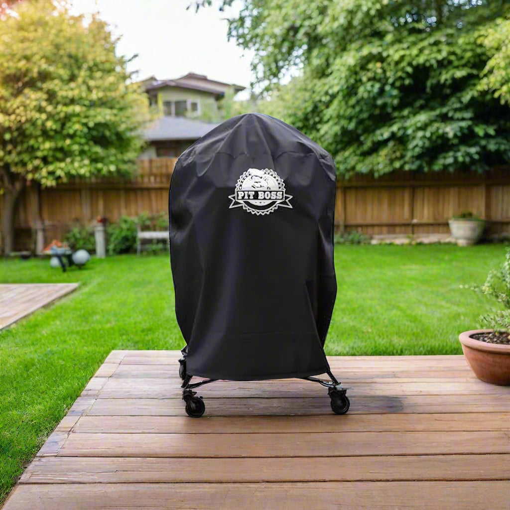 Pit Boss K24 Charcoal Grill Cover on a kamado grill, showing the Pit Boss logo on the front