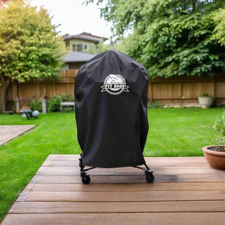 Pit Boss K24 Charcoal Grill Cover on a kamado grill, showing the Pit Boss logo on the front