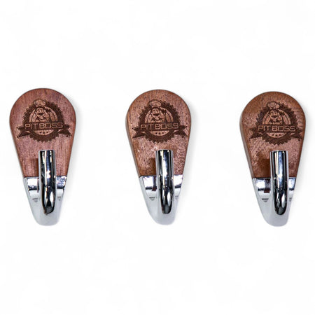 Close-up of a Pit Boss Magnetic Tool Hook, showcasing the engraved Pit Boss logo on the rosewood base