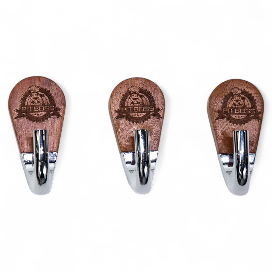 Close-up of a Pit Boss Magnetic Tool Hook, showcasing the engraved Pit Boss logo on the rosewood base