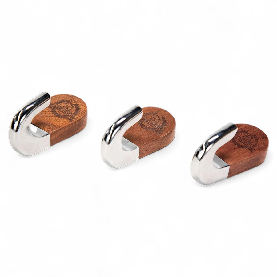 Three individual Pit Boss magnetic hooks with a blend of natural wood grain and polished metal