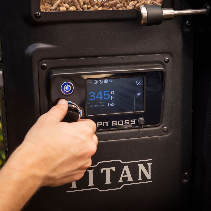 Close-up of the Pit Boss Titan Wood Pellet Grill's digital control panel, showing the temperature setting and pellet hopper for automatic fuel feeding.