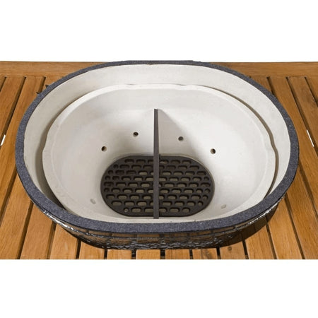The Primo Ceramic Grills Cast Iron Firebox Divider positioned inside a ceramic grill, showing its function