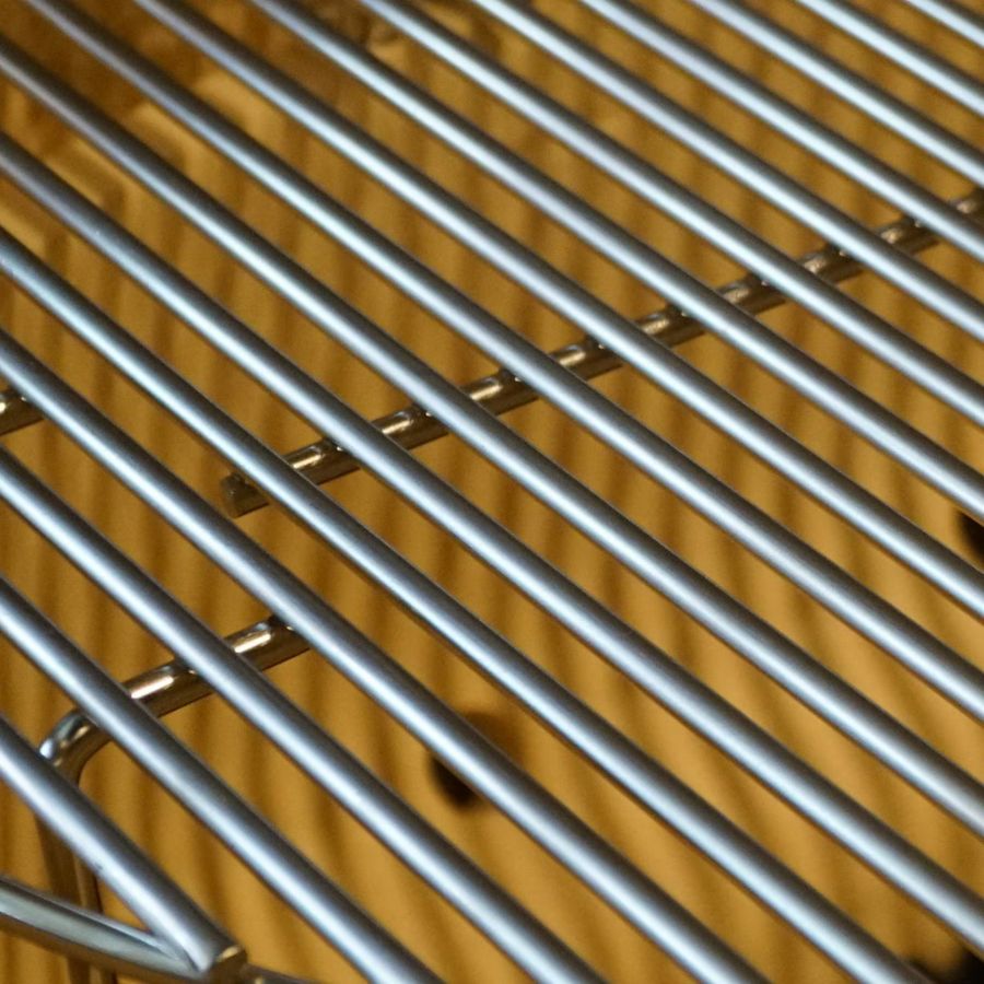 Close-up of stainless steel cooking grates inside Primo Oval Large